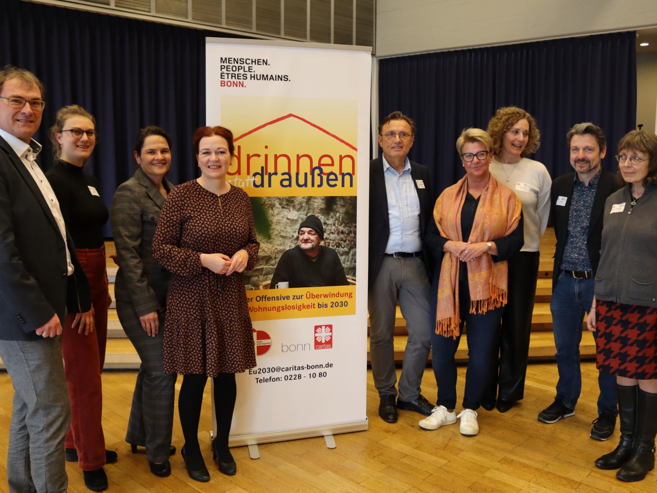 Gemeinsam gegen Wohnungslosigkeit: (v.l.) Caritasdirektor Jean-Pierre Schneider, Helena Marx und Munirae Gharevi von der Geschäftsstelle der Offensive, Oberbürgermeisterin Katja Dörner, Gerhard Roden vom Fachbereich Wohnungslosigkeit der Caritas, Sozialamtsleiterin Anja Ramos, Sozialdezernentin Carolin Krause, Abteilungsleiter Sozialamt Peter Tilgen und VfG-Geschäftsführerin Nelly Grunwald.